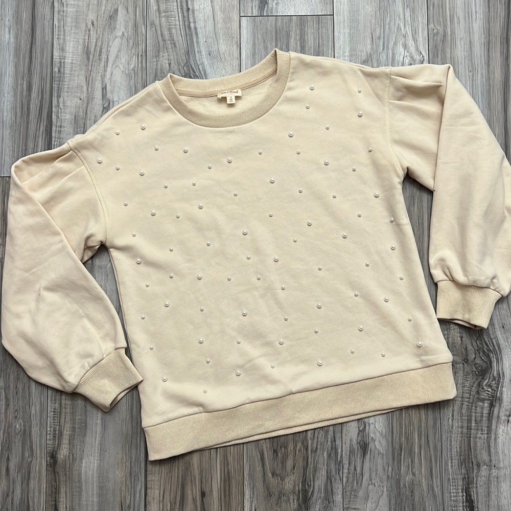 Creamish colored sweater with white pearls on front
